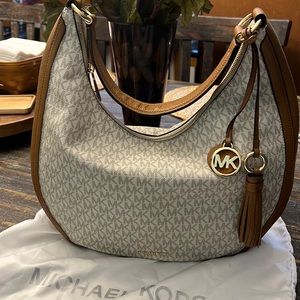 Large, vanilla Michael Kors bag with gold hardware.